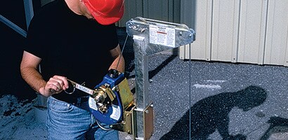 Worker operating winch ladder safety system
