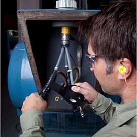 Electrician repairing motor lead splice with electrical tape.