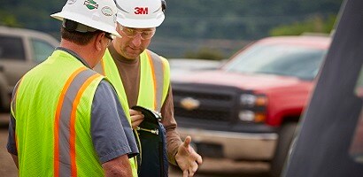 Worker wearing fall protection PPE standing on demonstration platform
