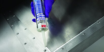Technician seals a corner with a metal to metal adhesive
