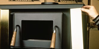 A hand applying decorative trim to an appliance

