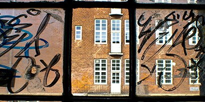 Glass is painted over with graffiti.
