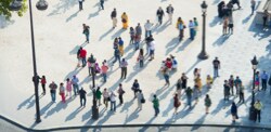 Aerial view of many people standing in a plaza.

