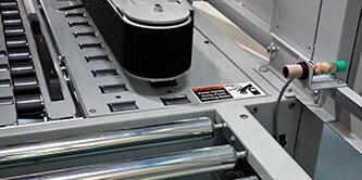 Imagem focada da correia de tração em um Fechador de Caixas 3M-Matic™.
