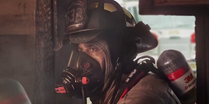 firefighter entering a building wearing a Vision C5 facepiece

