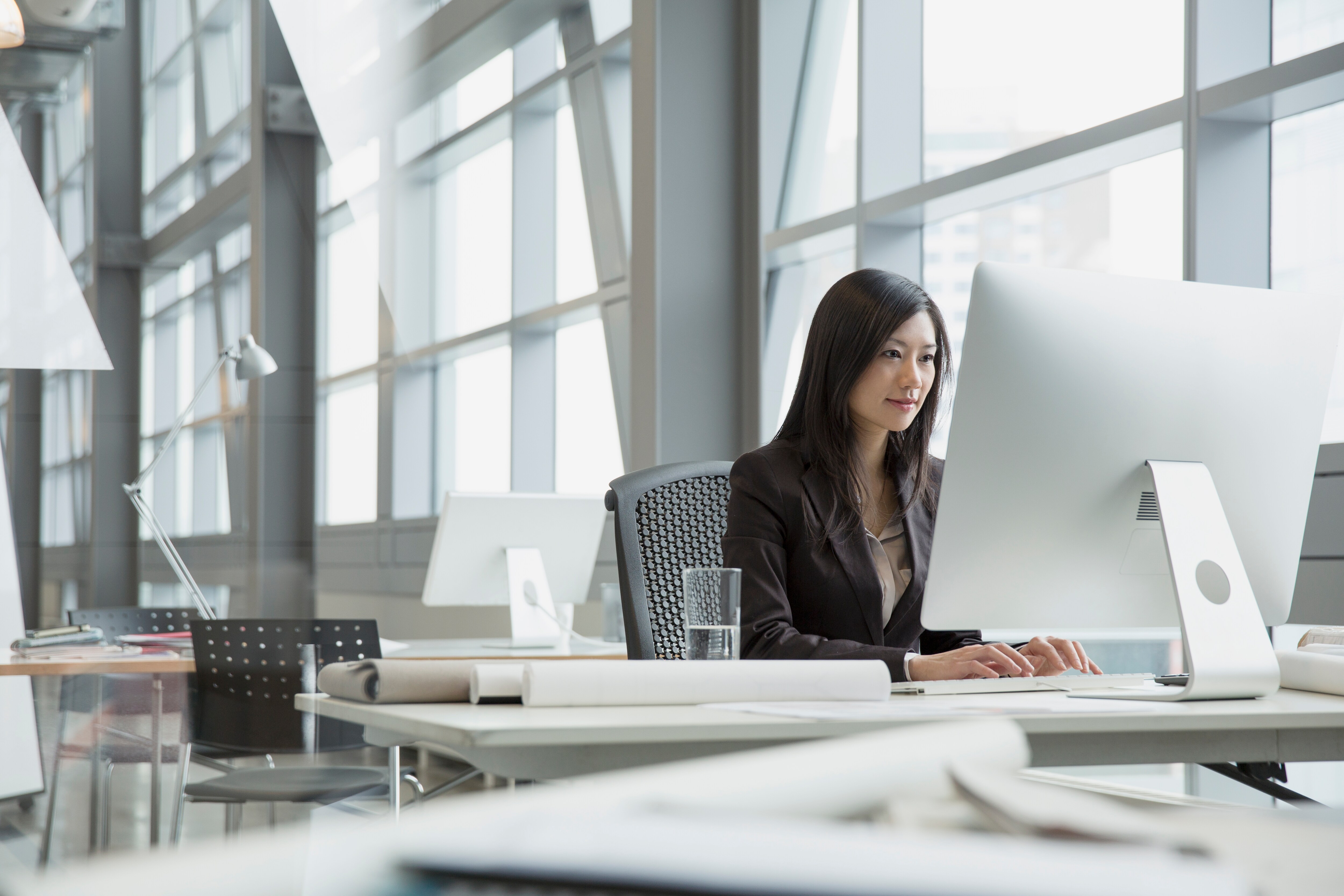 Inviting chairs sit near a sun-filled window. 3M™ Window Films increase comfort and conserve energy.