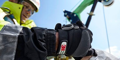 Worker in fall protection gear climbing ladder in fall protection training facility
