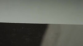 Video still showing a metal substrate before abrasion