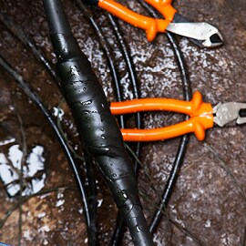 Electricians tools and electrical tape in a greasy environment.