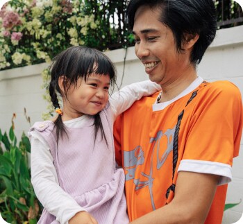 A man holding his young daughter.

