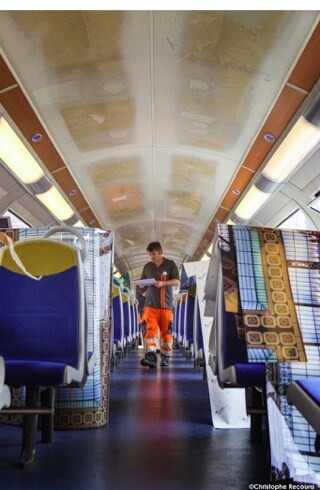 Interior of Paris train ceiling covered in 3M graphic film that displays classic artwork above the heads of passengers.