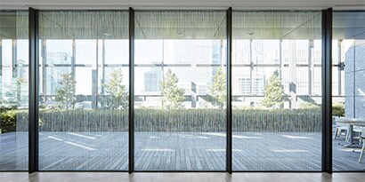Light filters through windows in an office with window finishes.
