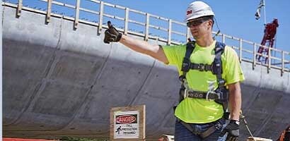 Worker on job site wearing fall protection PPE
