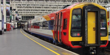 Image of a passenger train in an enclosed repair station
