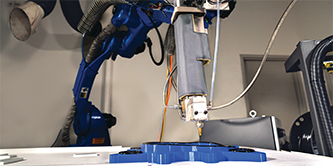 Imagem de um braço robótico aplicando a 3M™ Fita Extrudável VHB™ em uma peça complexa em profundidades variadas.
