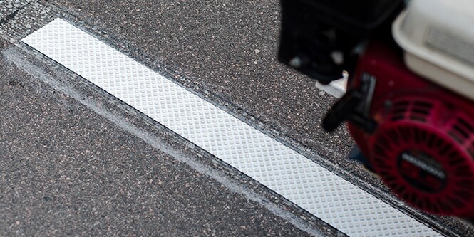 A strip of 3M Stamark high performance pavement marking tape applied to a road.
