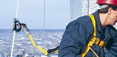 Worker at height with lanyard connected to cable rope grab
