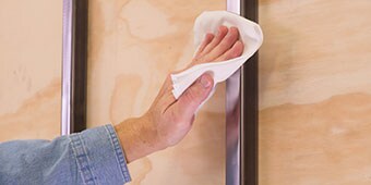 Image of someone doing a quick solvent wipe on a metal post

