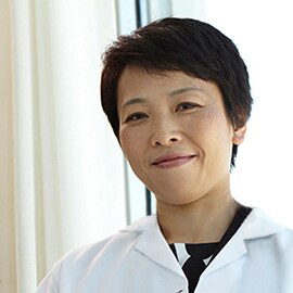 Female, Asian doctor in a white coat