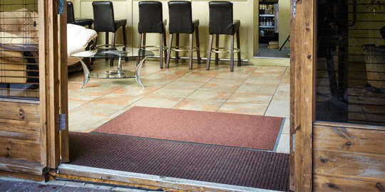 Mats lie at the entrance of a restaurant.
