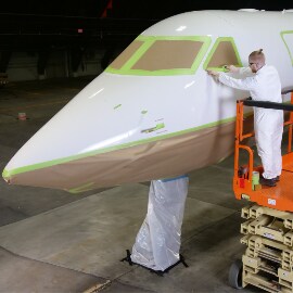 Image of a worker masking an airplane
